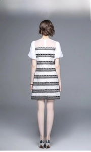 Back view of a tweed-style dress featuring black and white lace texture and zipper