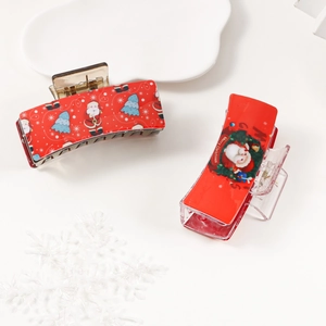 Deux pinces à cheveux rouges en acrylique avec motifs Père Noël et sapin de Noël