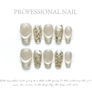 Handmade press-on nails set featuring champagne gold sequins and cat-eye effect finishes
