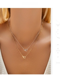 Detail of s925 silver layered necklace with interlocked gold and silver rings