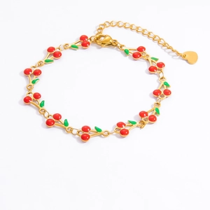 Detail of 18k gold plated cherry bracelet featuring red enamel charms and lobster clasp