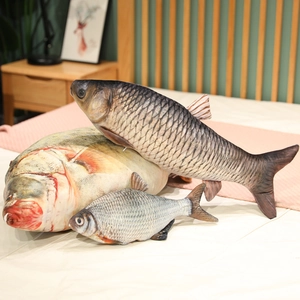 Detailed view of realistic 3D printed fish plush pillows in various sizes on a bed