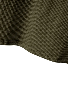 Close-up of olive green waffle knit fabric texture and high-quality hem stitching details