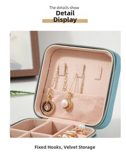 Detail view of velvet jewelry organizer box with necklace hooks and ring slots