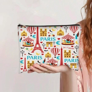 Detail of Paris theme canvas pouch held by hand featuring Eiffel Tower and monuments