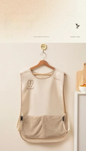 Detail of waterproof apron featuring a rabbit print and large brown absorbent pocket