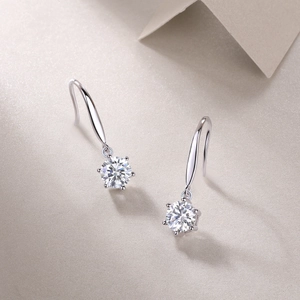 Detailed view of silver long drop earrings with brilliant-cut moissanite stones