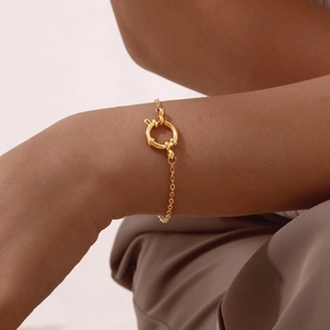 Close-up of 18K gold plated stainless steel bubble link bracelet on a female wrist