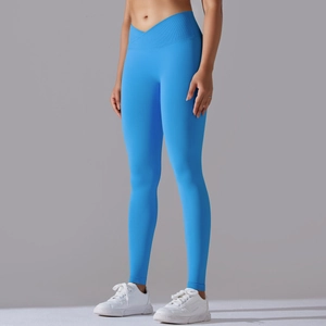 Detail of bright blue seamless yoga leggings with cross-waist design and elastic fabric