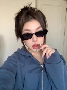 Asian model wearing black retro oval sunglasses with a blue hoodie and beaded necklace