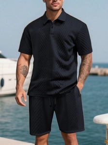 Detail of navy blue jacquard knit fabric on a men's summer polo and shorts set