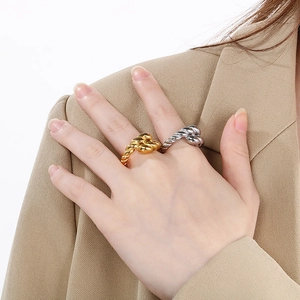 18K gold and silver plated twisted rope rings shown on model with chic camel blazer