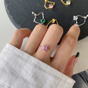 Detail view of S925 silver chain ring with oval pink zircon in a prong setting