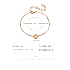 Detail view of 12mm circular letter K pendant on a delicate gold chain bracelet