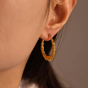 18K gold plated heart twisted hoop earrings with textured finish on model