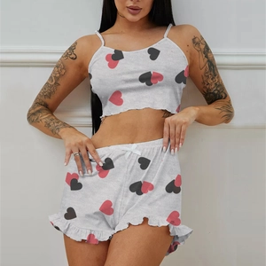 Women's two-piece gray pajama set with pink heart prints and ruffled hem shorts