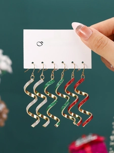 Three pairs of colorful spiral geometric earrings with glitter finish on display card