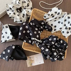 Floral satin scrunchie and headband with pearls in a retro black and white aesthetic