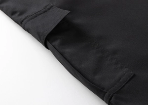 Detailed close-up of the black cargo shorts showing high-quality stitching on the pocket flap