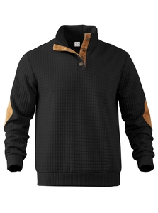 Detail of black quilted sweatshirt featuring brown collar accents and diamond texture