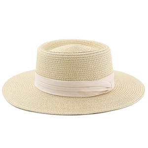 Close-up of beige boater straw hat with elegant satin ribbon detail for sun protection