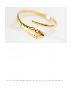 Macro shot of 14K gold plated stainless steel snake ring featuring sparkling crystal eyes