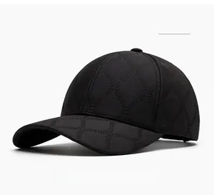 Close-up of black baseball cap featuring textured diamond jacquard fabric and curved brim
