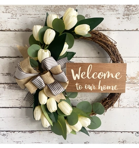 Rustic tulip wreath with eucalyptus leaves and Welcome to our home wooden sign detail