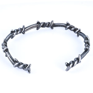 Close-up of antique silver barbed wire bangle with vintage oxidized finish details