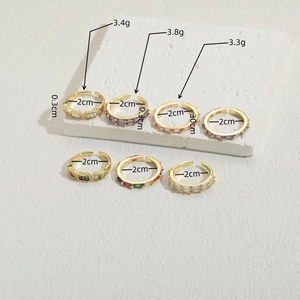 14K gold plated zircon stacking rings with colorful rectangular crystals on stone tray