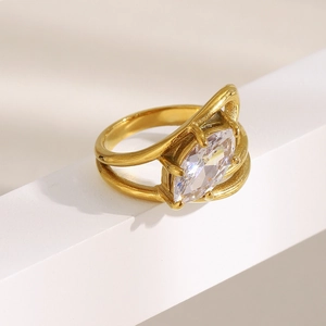 Detail view of gold stainless steel double layer ring with marquise cut zircon on white stairs