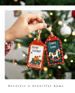 Detailed close-up of festive wooden Christmas tree ornaments featuring hand-held holiday decor