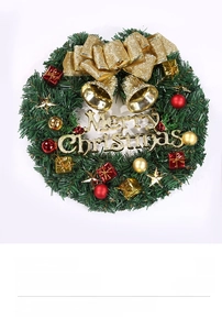 Detail of Christmas wreath with golden bow, bells, and Merry Christmas sign on pine needles