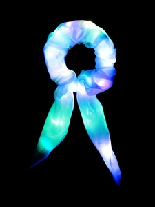 Detail of LED light-up scrunchie with bow showing blue and purple glowing fabric