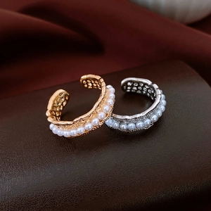 Detail of hollow honeycomb texture on 18K gold and silver plated pearl ear cuffs