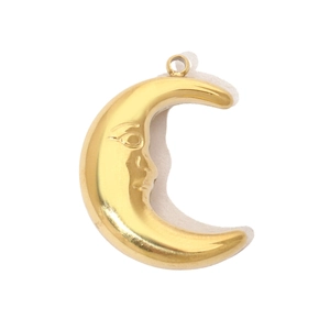 Macro detail of a 14K gold plated crescent moon pendant with face carving for necklaces