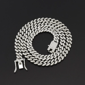 Macro shot of 8mm silver Cuban link chain with rhinestone pavé and secure box clasp