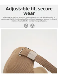 Detail of khaki cotton baseball cap showing adjustable silver buckle and fabric texture