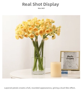 Close-up of artificial yellow camellia tea buds in a glass vase for home decoration