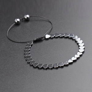 Detail of hand-woven hematite heart bracelet with adjustable magnetic bead closure