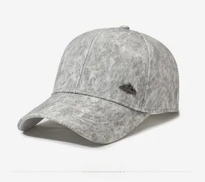 Detail shot of grey marble texture fabric on a baseball cap with mountain metal badge