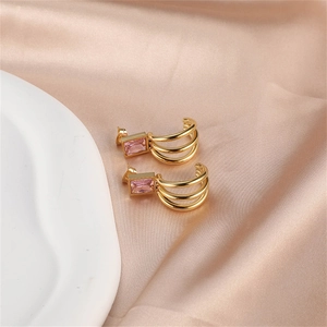 Detail of gold-plated hoop earrings with two pink rectangular cubic zirconia stones