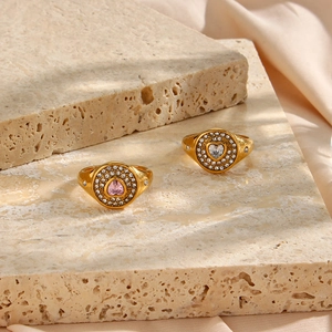 Detail of 18K gold-plated signet rings with heart-shaped pink and clear zircon stones