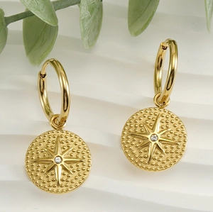 Detail of 18K gold-plated stainless steel hoop earrings with starburst crystal pendant
