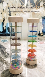 Close-up of Morandi and rainbow rainmaker toys with colorful beads and wooden ends