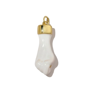 Macro detail of Mano Figa pendant charm in white resin and polished gold hardware