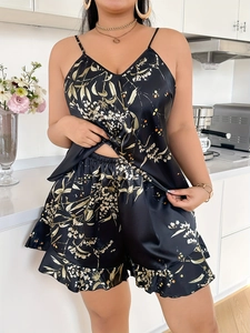 Detail of black floral satin pajama set featuring silk-like texture and ruffled edges