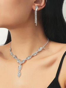 Close-up of bridal jewelry set with sparkling rhinestones worn by a model