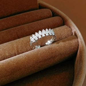 Macro shot of rectangular cut cubic zirconia stones set in a silver open ring design