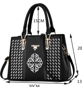 Detailed view of black faux leather tote with floral embroidery and size specifications